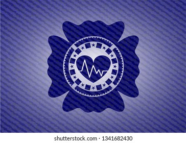 heart with electrocardiogram icon inside badge with denim texture