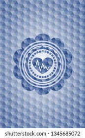 heart with electrocardiogram icon inside blue emblem with geometric background.