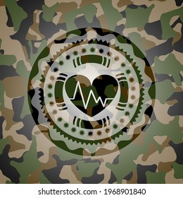 heart with electrocardiogram icon inside camo emblem. 