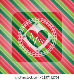 heart with electrocardiogram icon inside christmas colors badge.