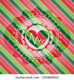heart with electrocardiogram icon inside christmas colors badge.