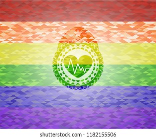 heart with electrocardiogram icon inside emblem on mosaic background with the colors of the LGBT flag