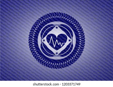 heart with electrocardiogram icon inside emblem with denim texture