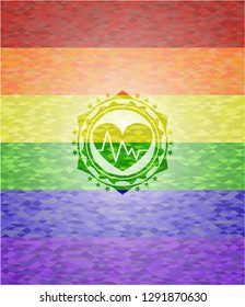heart with electrocardiogram icon inside emblem on mosaic background with the colors of the LGBT flag