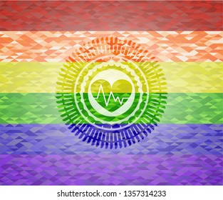 heart with electrocardiogram icon inside emblem on mosaic background with the colors of the LGBT flag