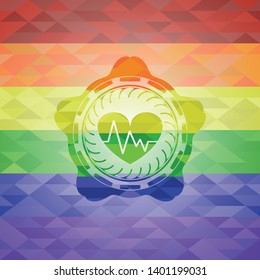 heart with electrocardiogram icon inside emblem on mosaic background with the colors of the LGBT flag