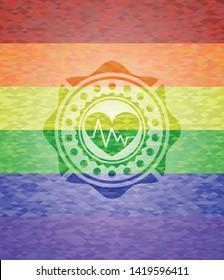 heart with electrocardiogram icon inside emblem on mosaic background with the colors of the LGBT flag
