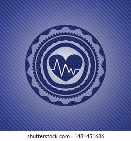 heart with electrocardiogram icon inside emblem with jean high quality background