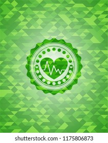 heart with electrocardiogram icon inside green emblem. Mosaic background