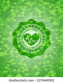 heart with electrocardiogram icon inside green emblem with triangle mosaic background