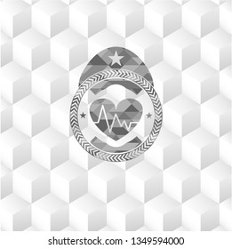 heart with electrocardiogram icon inside grey badge with geometric cube white background
