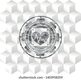 heart with electrocardiogram icon inside grey badge with geometric cube white background