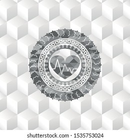 heart with electrocardiogram icon inside grey icon or emblem with geometric cube white background
