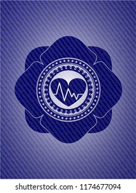 heart with electrocardiogram icon inside jean or denim emblem or badge background