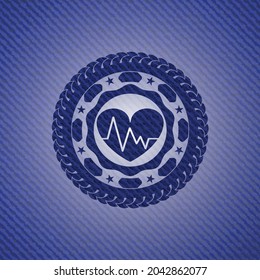 heart with electrocardiogram icon inside jean or denim emblem or badge background. 