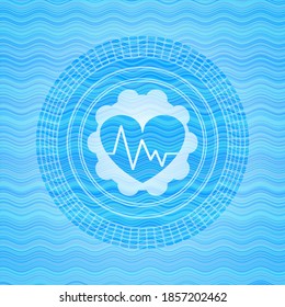 heart with electrocardiogram icon inside light blue water badge. 