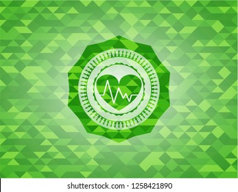 heart with electrocardiogram icon inside realistic green mosaic emblem
