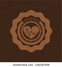 heart with electrocardiogram icon inside realistic wood emblem