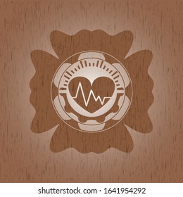 heart with electrocardiogram icon inside retro wood emblem