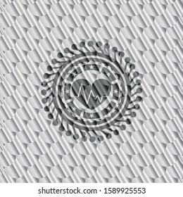 heart with electrocardiogram icon inside shiny silver badge. Scales pattern. Vector Illustration. Detailed.