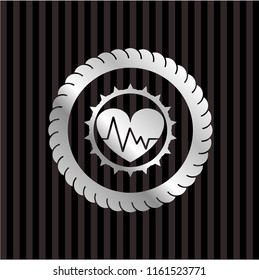 heart with electrocardiogram icon inside silver badge