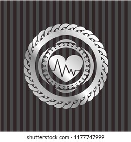 heart with electrocardiogram icon inside silvery emblem or badge