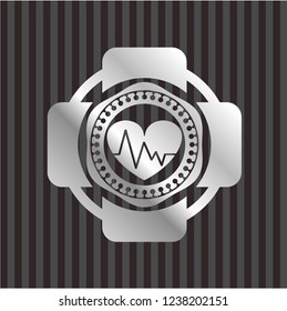 heart with electrocardiogram icon inside silvery emblem or badge