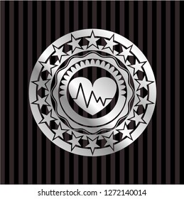 heart with electrocardiogram icon inside silvery emblem