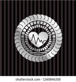 heart with electrocardiogram icon inside silvery badge or emblem