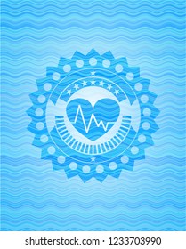 heart with electrocardiogram icon inside water concept badge.