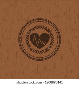 heart with electrocardiogram icon inside wood emblem. Retro