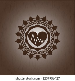 heart with electrocardiogram icon inside wood emblem. Vintage.
