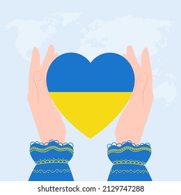 Heart flag of Ukraine in female hands. Concept - no war in Ukraine.