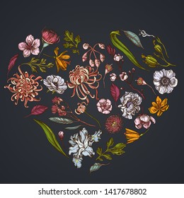 Heart floral design on dark background with japanese chrysanthemum, blackberry lily, eucalyptus flower, anemone, iris japonica, sakura