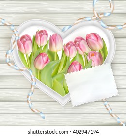 Heart frame with fresh tulips on white wooden background. EPS 10 vector file included