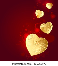 Heart of gold foil on a red glowing background.