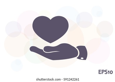 Heart in hand vector icon.
