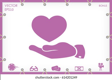 Heart in hand vector icon.