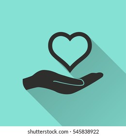 Heart in hand vector icon. Black illustration isolated on green background for graphic and web design.