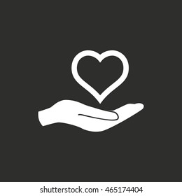 Heart in hand vector icon. White illustration isolated on black background for graphic and web design.