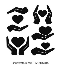 Heart in hands black color vector icon set isolated on white background. Organ donation, people support concept. Flat simple design illustration for apps, logo and website. Hands holding heart.