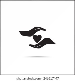 Heart in hands vector icon