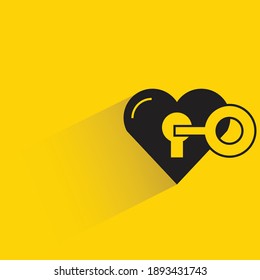 heart and key with shadow on yellow background