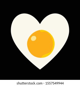 Heart made from fried egg isolated on black background. Fried egg heart-shaped