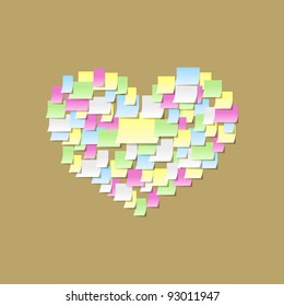 Heart made of sticky notes on a cork board