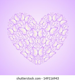 Heart made of violet butterflies isolated on green