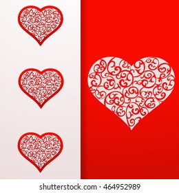 Heart openwork card on red background. 