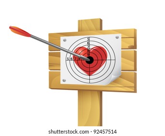 Heart pierced by an arrow on a target placed on wooden boards