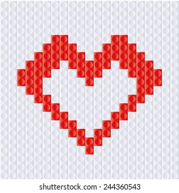 Heart from plastic bricks on a white background. Red heart for love. Valentine day.