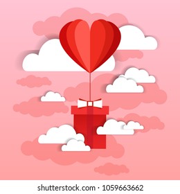 Heart Shaped Air Balloon Fly With Present Box Over Pink Sky And Clouds Background